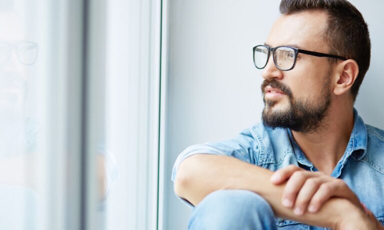 man sitting and reflecting on low testosterone levels, trt cost, low testosterone treatment cost