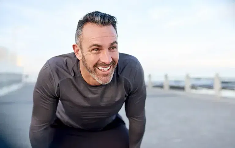 Man noticing the positive differences TRT therapy can bring to energy levels, confidence, and more